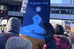 Photo of a protest with someone hold a sign saying "North Star Rising for Good." Photo of a protest with someone hold a sign saying "North Star Rising for Good."